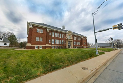 A red brick building with a white roof and a white trim around the windows.